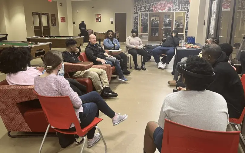 Alabama State University BCM students sit in a circle in student center talking about missions