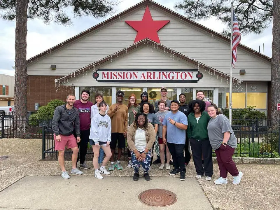 University of West Alabama BCM students and campus minister pose in front of Mission Arlington building