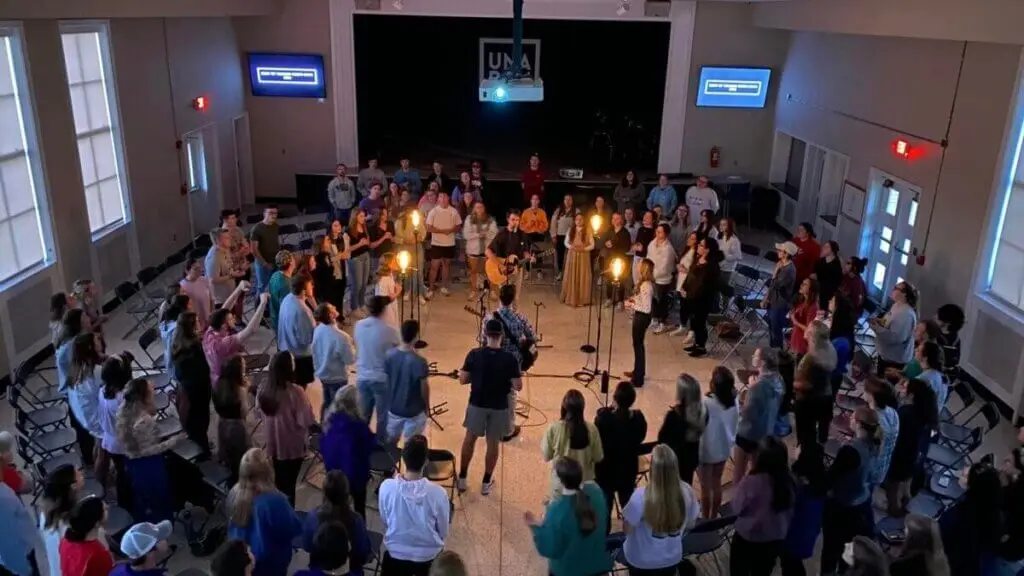 College students gather in circle for worship