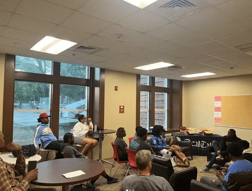 Tuskegee University BCM students sit on couches and chairs for bible study on campus