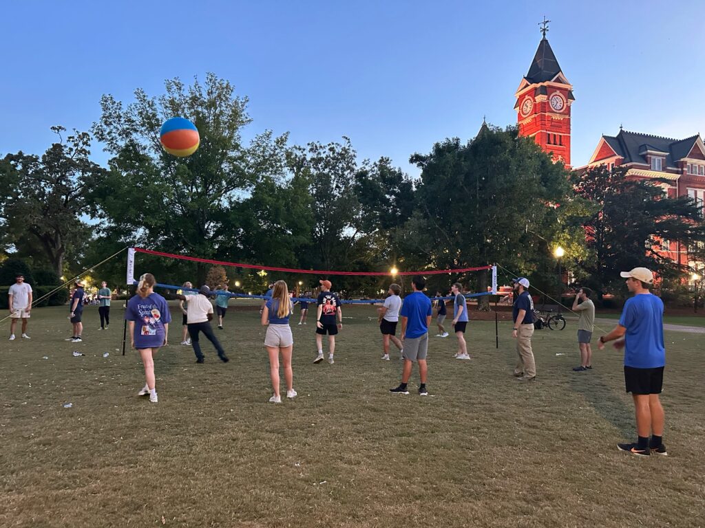 College students play volleyball on the front lawn of Samford Hall at Auburn University